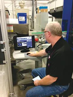 Scott Reilly, blow molding department manager, uses a vision inspection system on the KBB 60. Scott Reilly, blow molding department manager, uses a vision inspection system on the KBB 60.