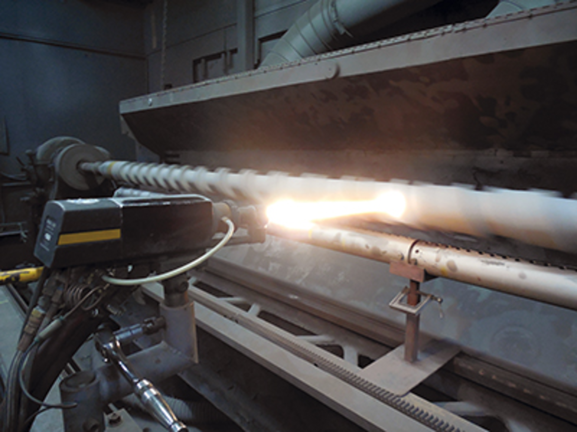 Extreme Coatings applies CarbideX CPR to a feed screw using a high-velocity oxygen-fueled spray gun.&Acirc;