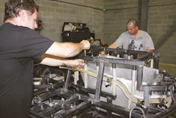 Simplay3 employees work on the skeleton of a spider, the metal structure that holds molds in a rotomolding machine. Simplay3 employees work on the skeleton of a spider, the metal structure that holds molds in a rotomolding machine.