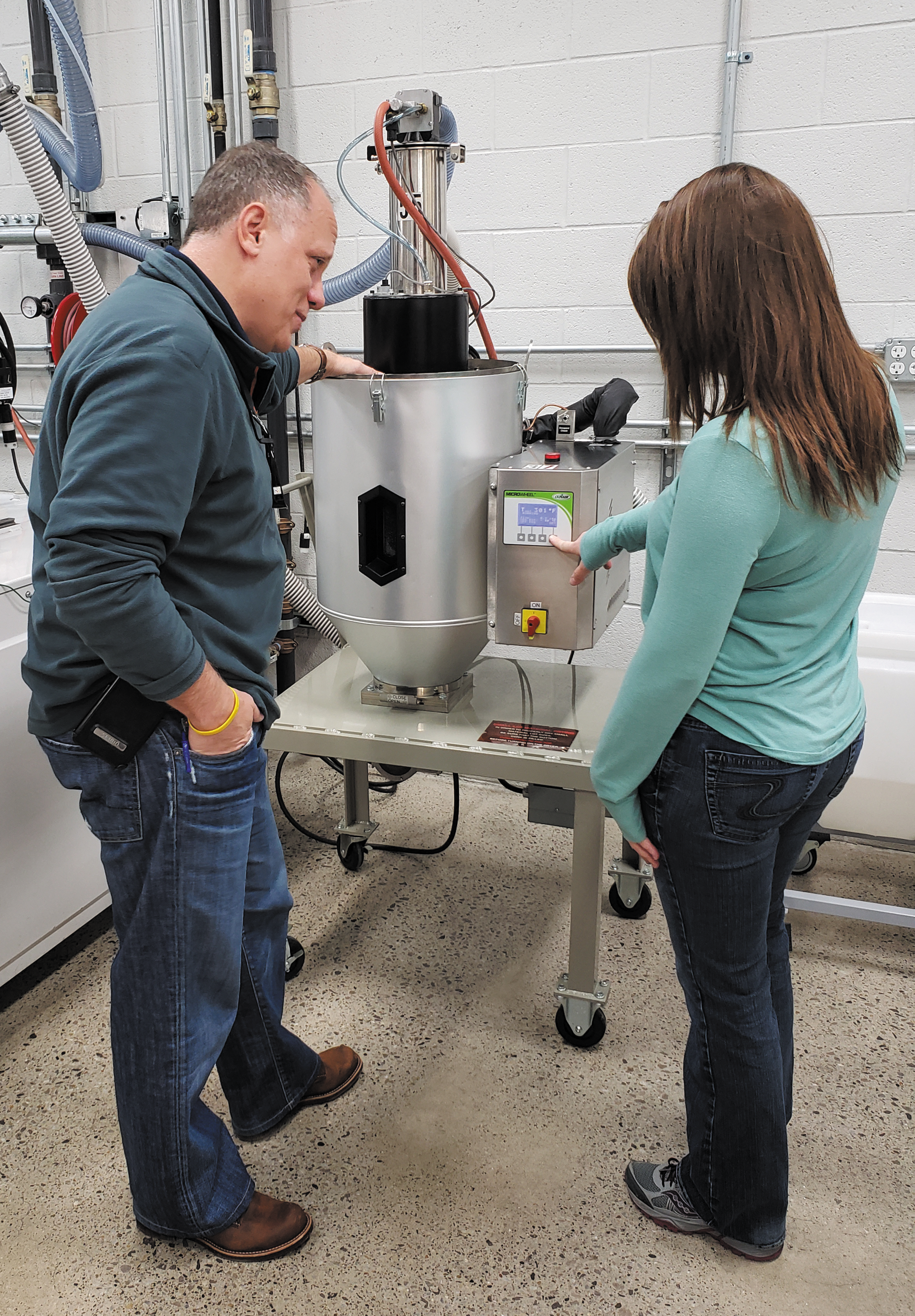 Matrix Tool GM Dave Moyak and engineer Savannah Custard check settings on one of the company&rsquo;s 20 Conair MicroWheel dryers.