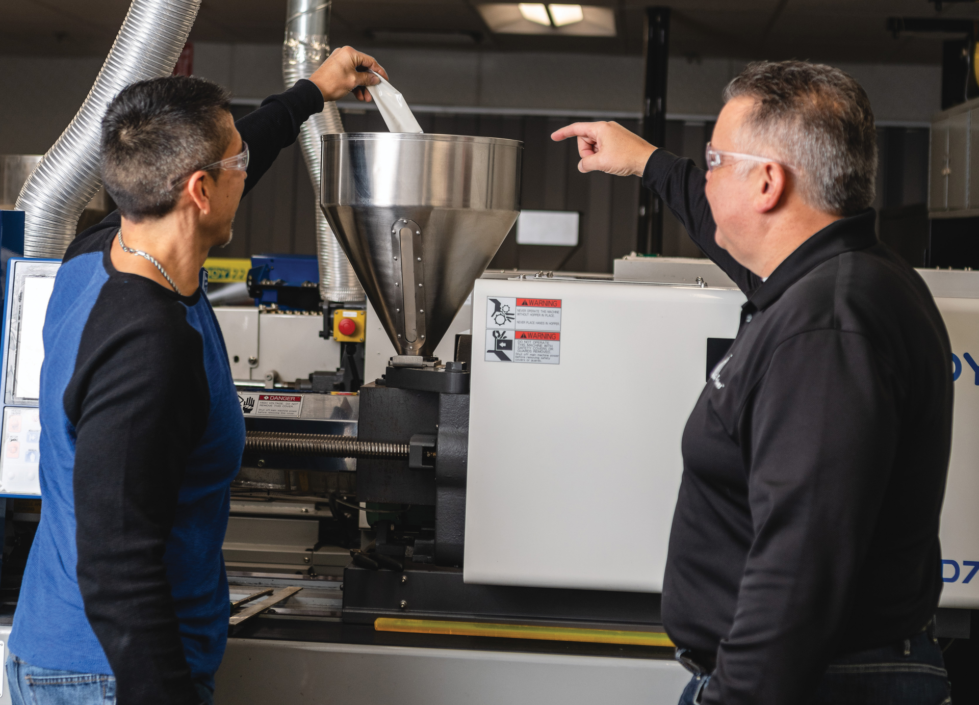 Technicians use iD Additives' QuickShots, a single-dose purging compound, to rinse out a machine.