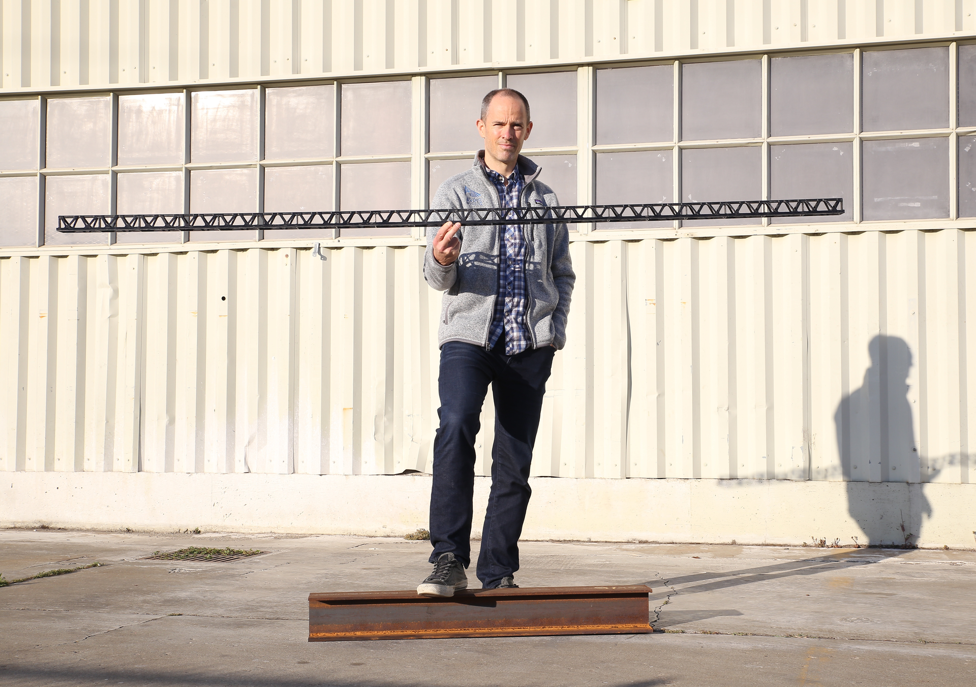 Arris Composites CEO Ethan Escowitz displays a truss made using his company's technology.
