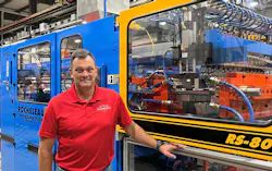 Steve Rocheleau with one of his company's extrusion blow molding machines. Steve Rocheleau with one of his company's extrusion blow molding machines.