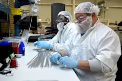 Workers examine tubing manufactured by Putnam Plastics. Workers examine tubing manufactured by Putnam Plastics.