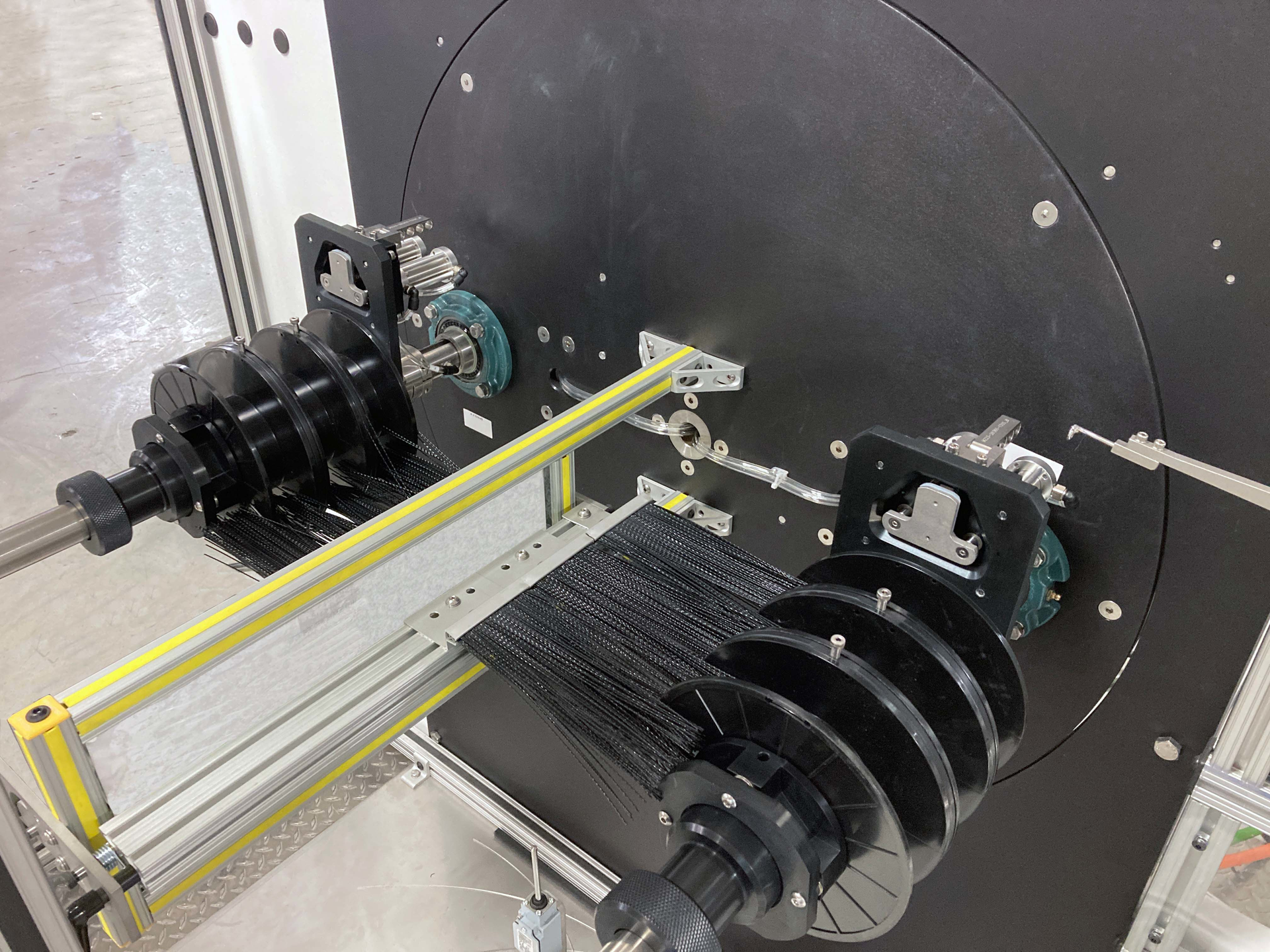 With the new feature, the coiler is programmed to wind one spool at a time until all the spools on one shaft are full. Then the coiler moves the shaft with empty spools into position.