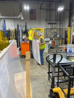 Workers move items at one of CKS' two Naugatuck, Conn., plants. The packaging products maker is a proponent of hiring people who have been incarcerated or unhoused.