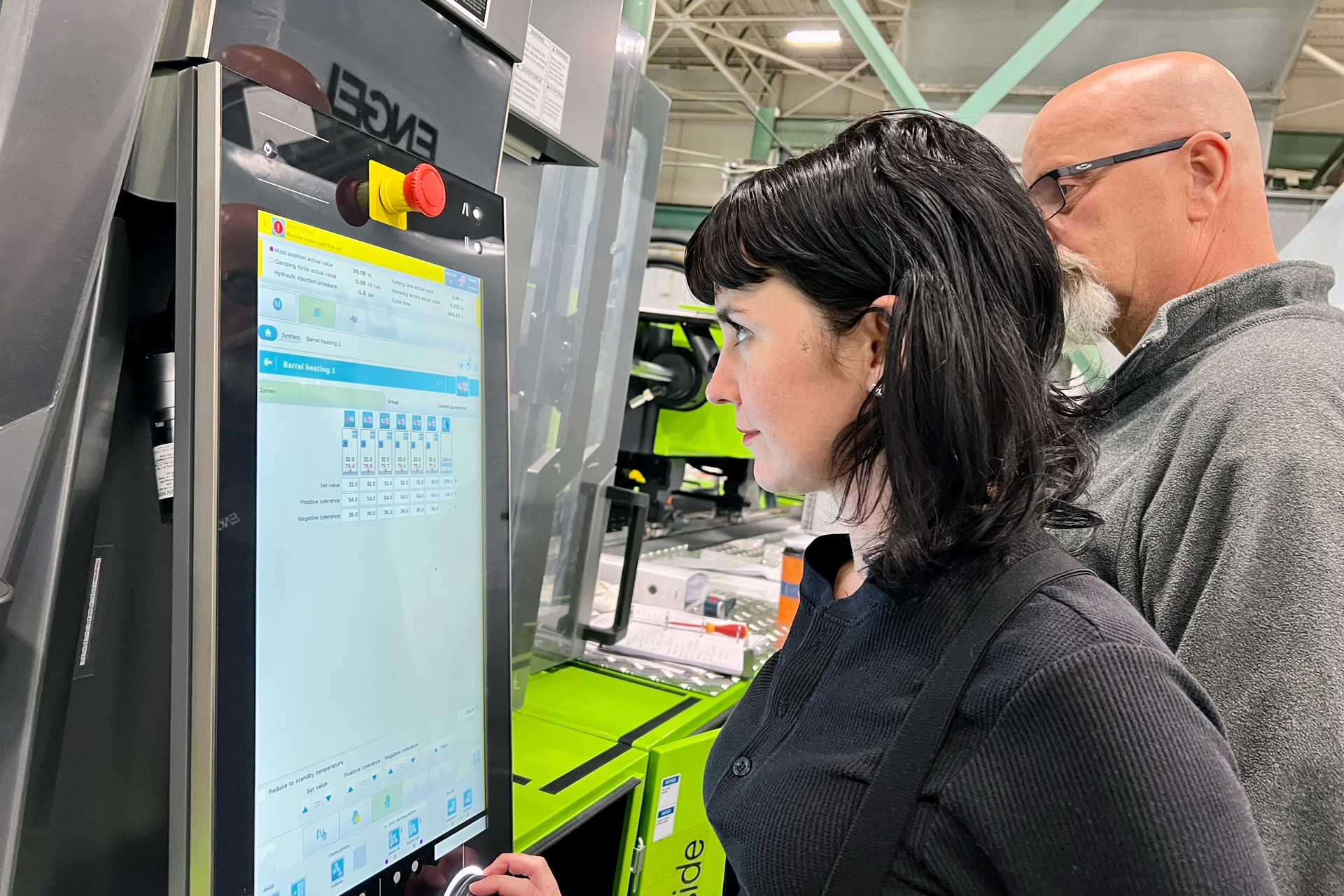 An Engel apprentice studies an interface under the supervision of a mentor.