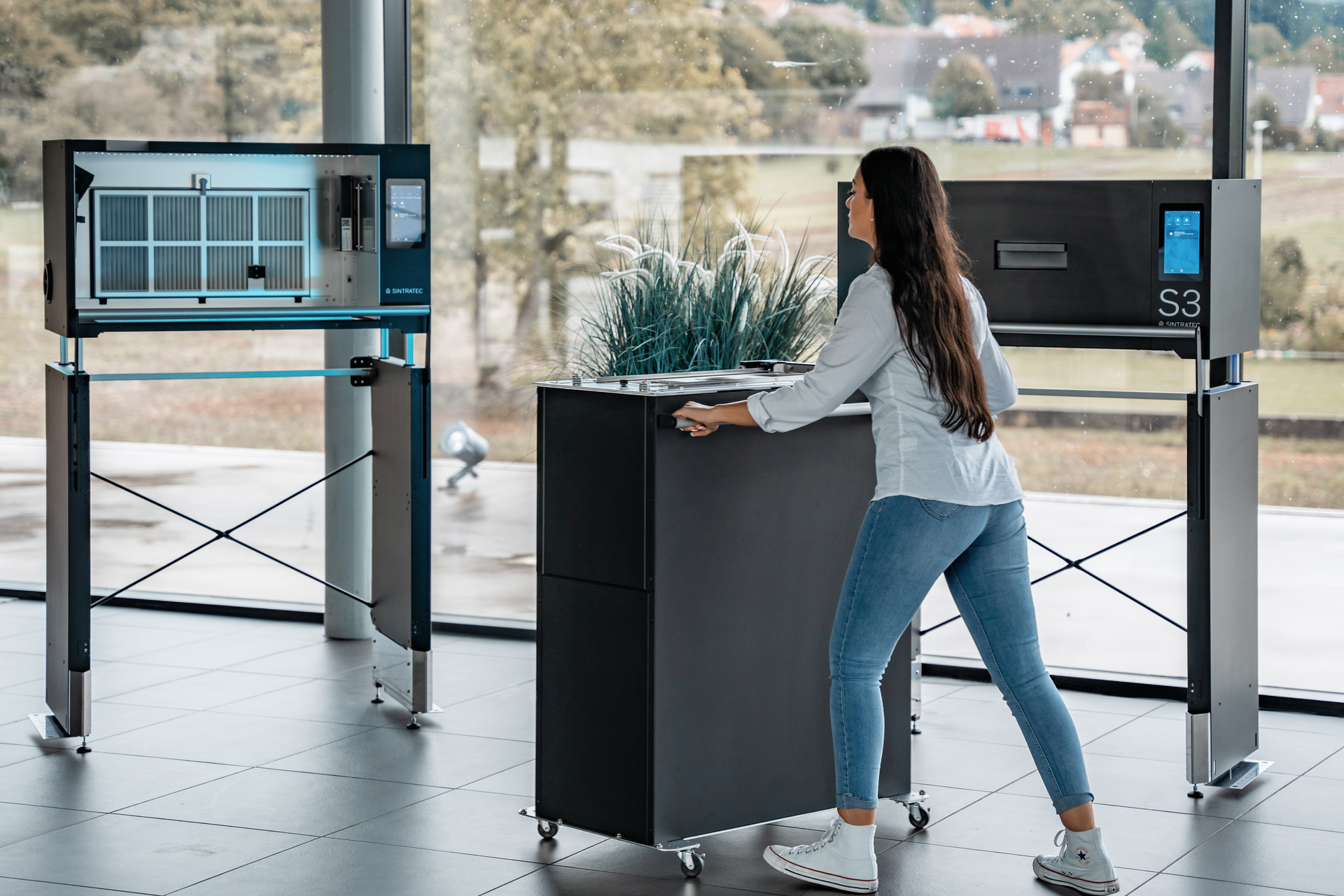 Sintratec&rsquo;s build modules can be wheeled from the fusion modules to a material-handling station for part cleaning and powder reclamation.