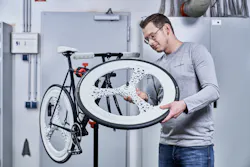 Advances in additive manufacturing make possible the production of very complex parts. Here, a man admires a bicycle's lightweight components, made by Voxeljet's VX1000 HSS 3D printer. Advances in additive manufacturing make possible the production of very complex parts. Here, a man admires a bicycle's lightweight components, made by Voxeljet's VX1000 HSS 3D printer.