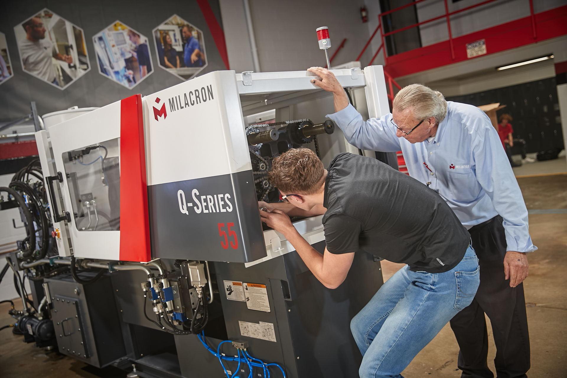 Grant Career Center student Jhace Pryor works with Daryll Martin, an instructor in the new Milacron Advanced Manufacturing Academy.