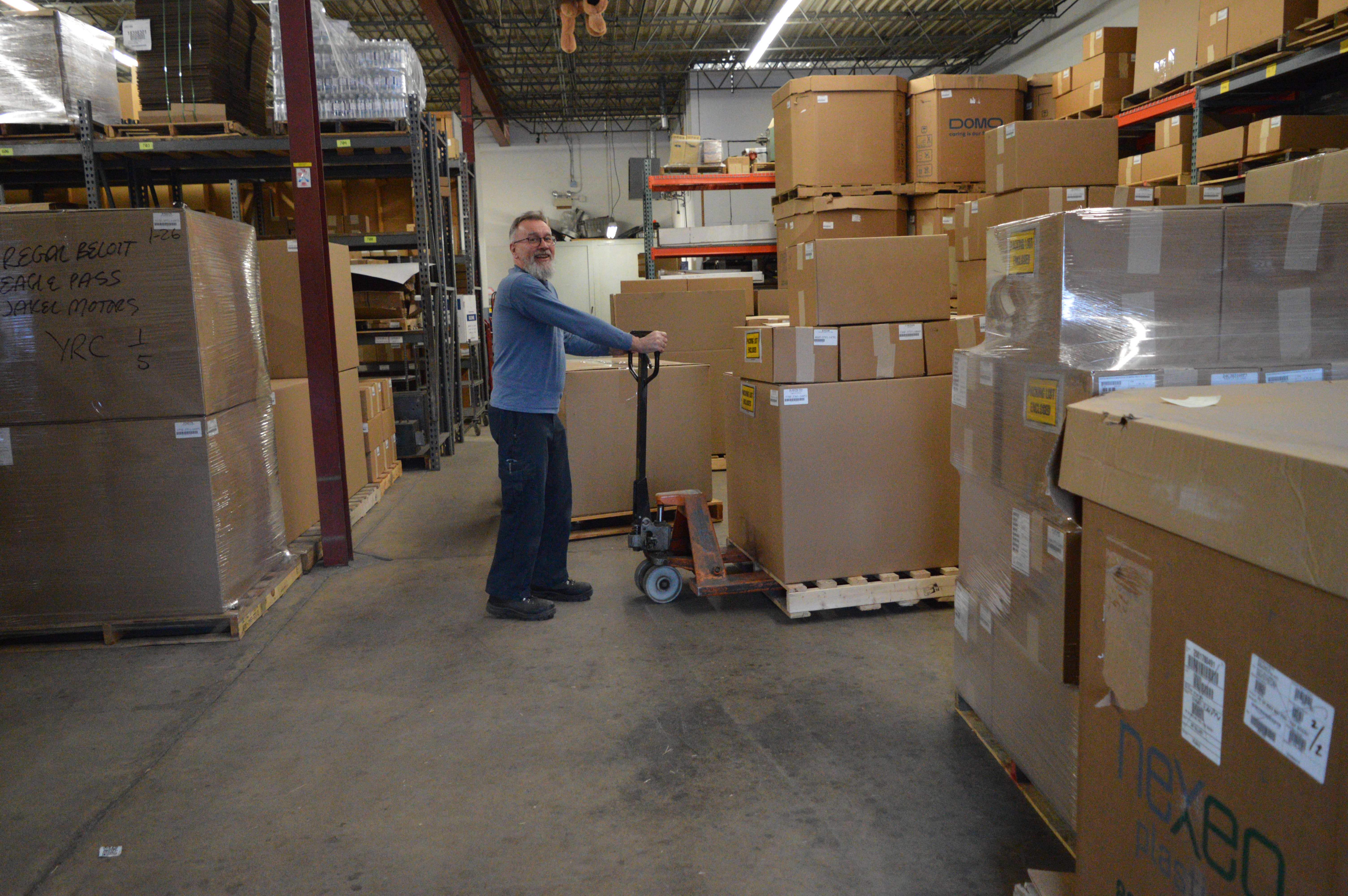 Warehouse manager Malcolm Osborne prepares to ship out a batch of fresh injection molded parts