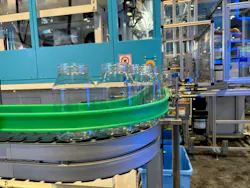 Blow molded jars whiz by on a line at NPE2024. Blow molded jars whiz by on a line at NPE2024.