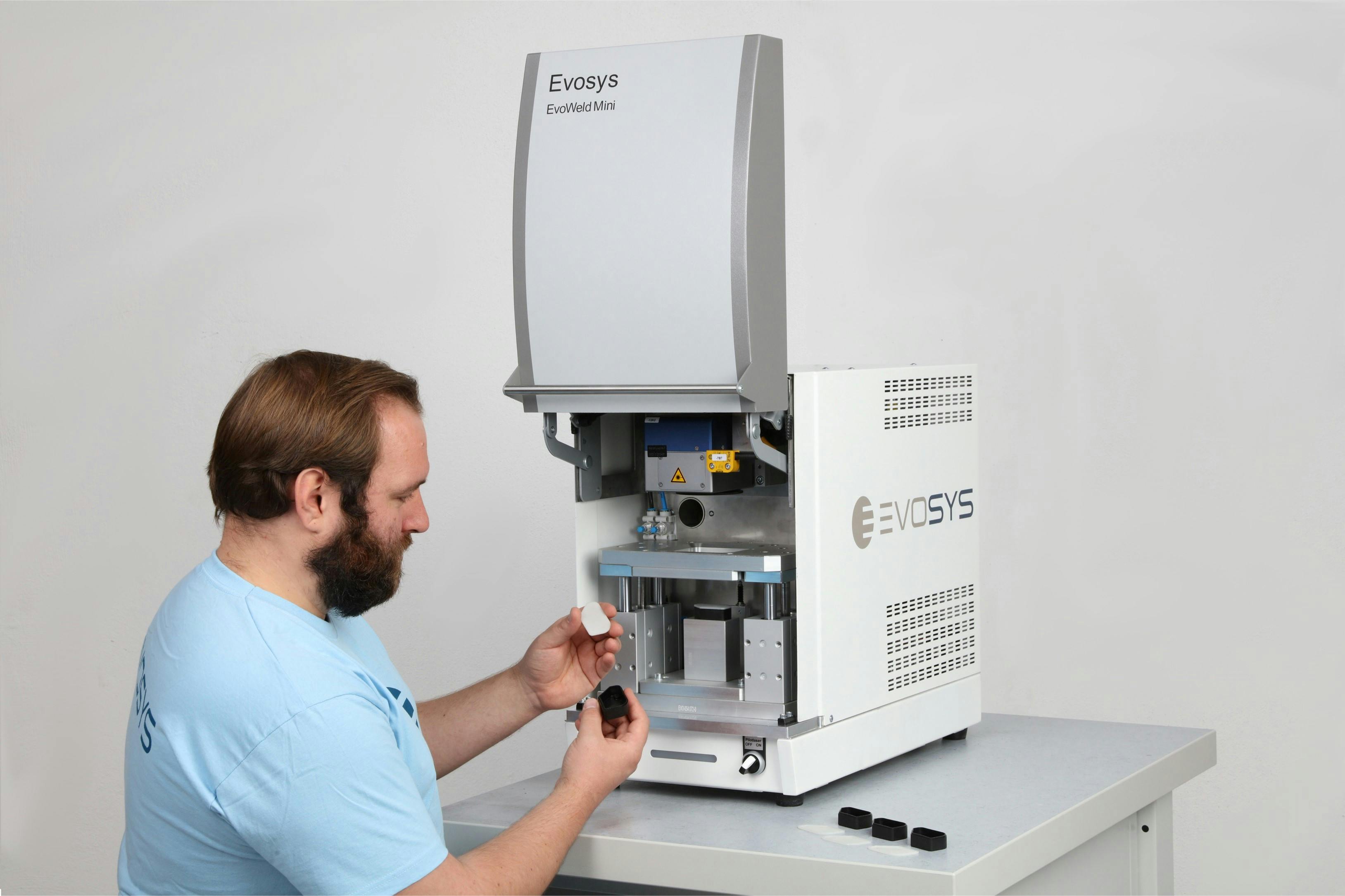 A worker works with Evosys' EvEvoWeld Mini. Though designed for smaller quantities and laboratory use, the welding system has some of the features of larger Evosys systems, so tasks easily scale up.