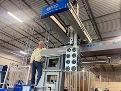 Jim Healy, VP of sales and marketing for Sepro America, poses alongside a large robot. Jim Healy, VP of sales and marketing for Sepro America, poses alongside a large robot.