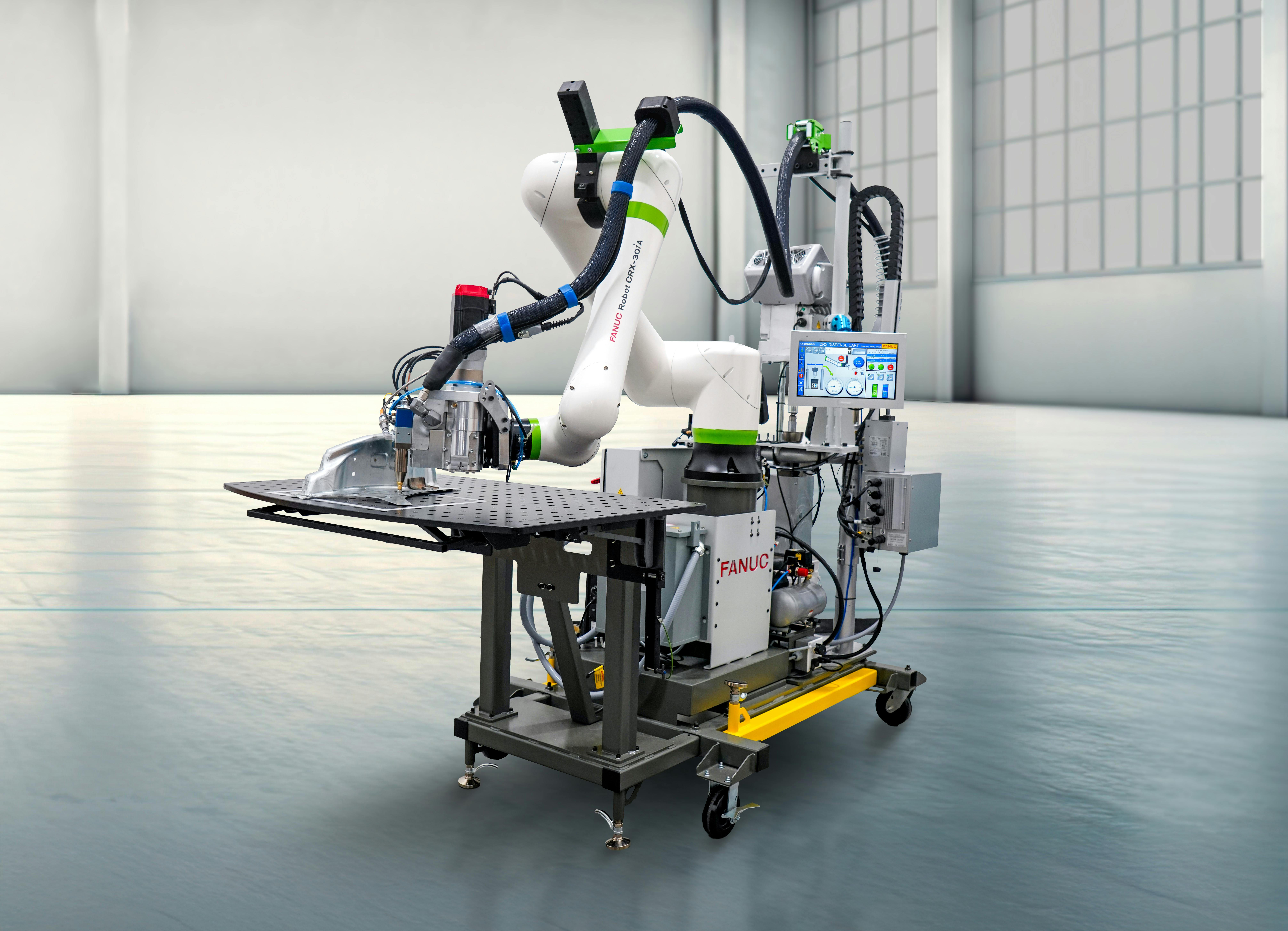 FANUC's adhesive dispensing system combines a cobot, metering system and vision software on a mobile cart.