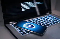 A locked phone sits on a laptop computer. A locked phone sits on a laptop computer.