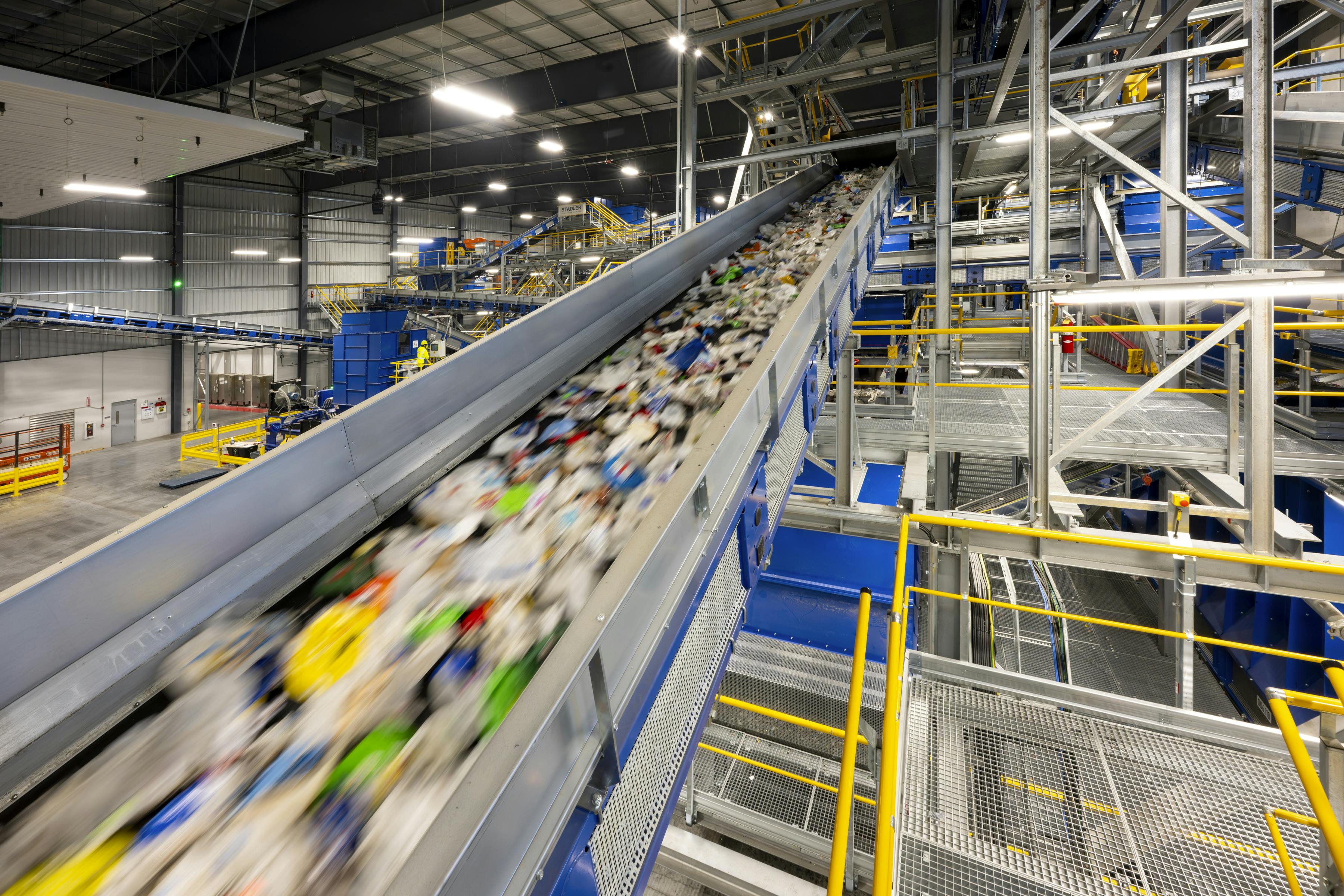 Recyclable material speeds on a conveyor line at the Indianapolis Polymer Center.
