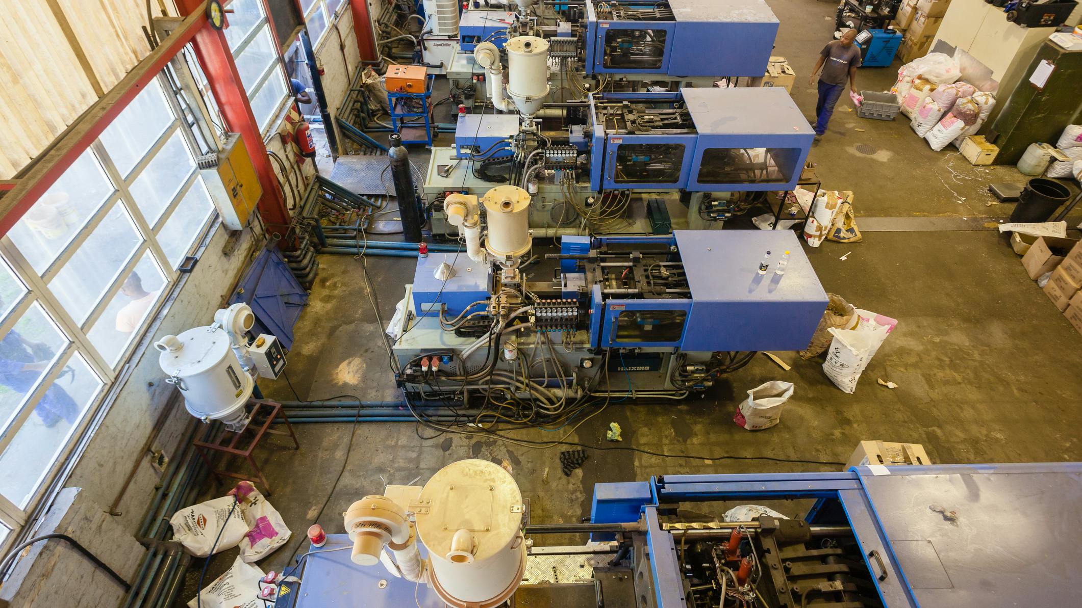 Injection molding machines on a shop floor.