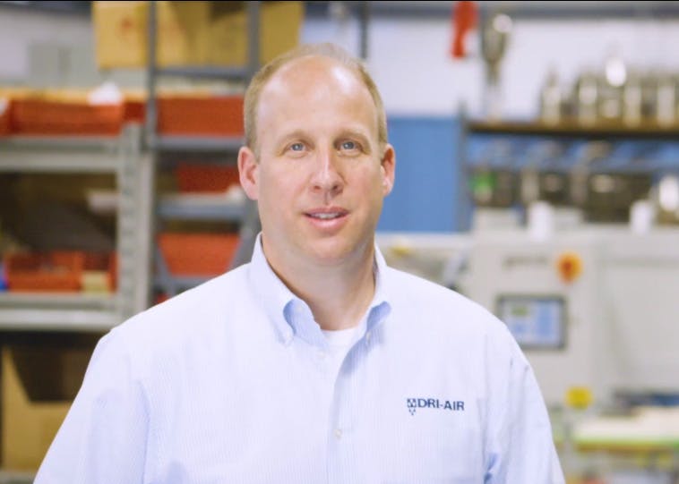 Jason Sears on shop floor in blue shirt