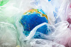 A globe surrounded by plastic bags symbolizes the world's plastic pollution problem. A globe surrounded by plastic bags symbolizes the world's plastic pollution problem.