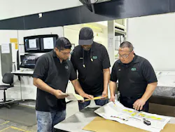 Employees look over materials regarding color matching at Union City, Calif., converter Emerald Packaging. Employees look over materials regarding color matching at Union City, Calif., converter Emerald Packaging.