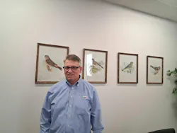 Glenn Frohring, one of the three owners of Absolute Haitian Corp., poses in front of a collection of artworks depicting birds. The pictures, which are gifts from his wife, decorate his Parma, Ohio, office. Glenn Frohring, one of the three owners of Absolute Haitian Corp., poses in front of a collection of artworks depicting birds. The pictures, which are gifts from his wife, decorate his Parma, Ohio, office.