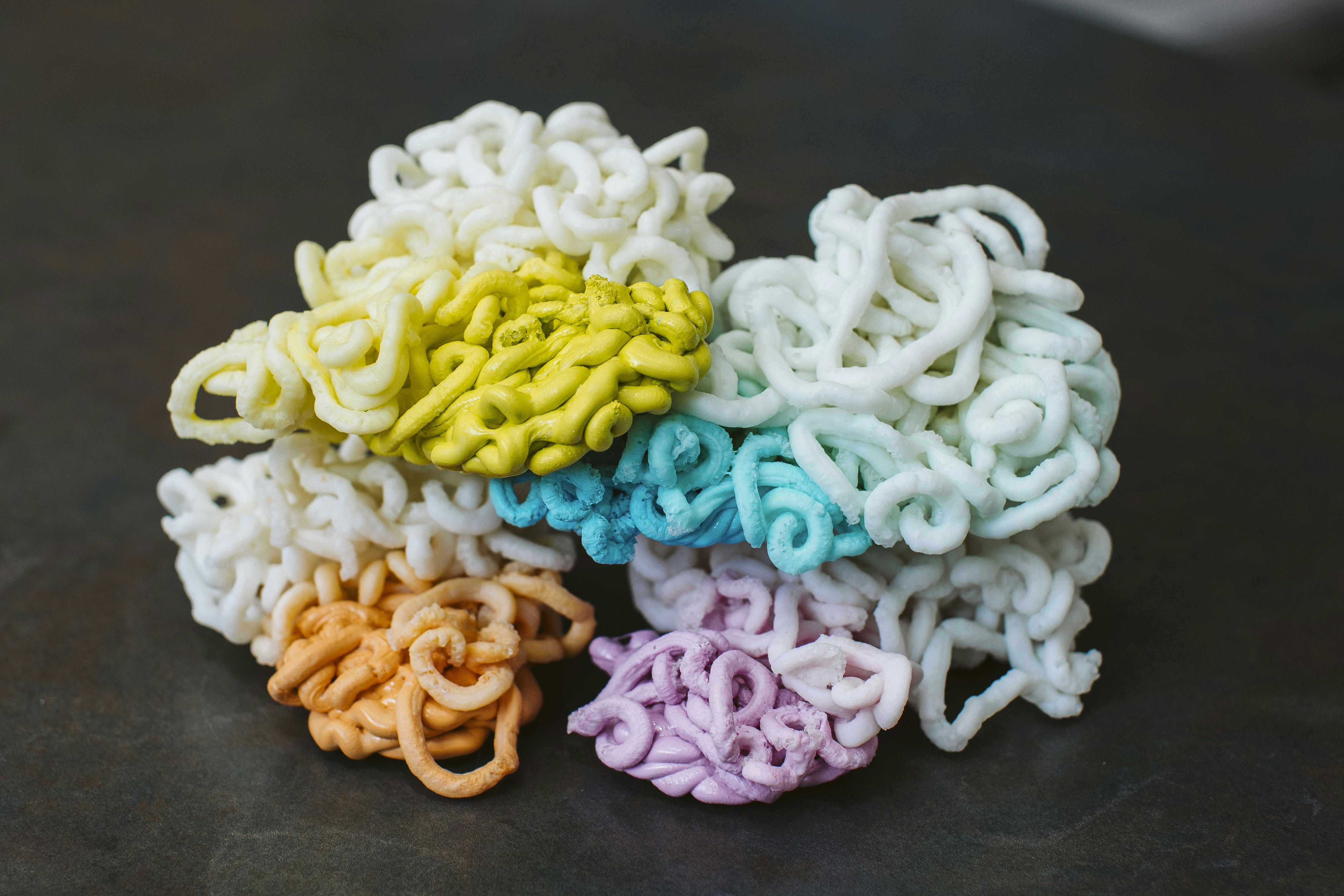 Shuman Plastics used E4 to purge an injection molding machine of colored plastics, producing these piles of plastics, chronicling the process from the beginning, starting with a colorant and ending when that colorant was completely drained from the system.