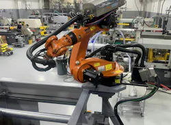 A robot works on a job at injection molder Champion Plastics. A robot works on a job at injection molder Champion Plastics.