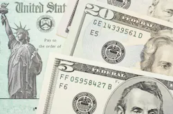 U.S. Treasury check with $5 and $20 bills overlaid U.S. Treasury check with $5 and $20 bills overlaid