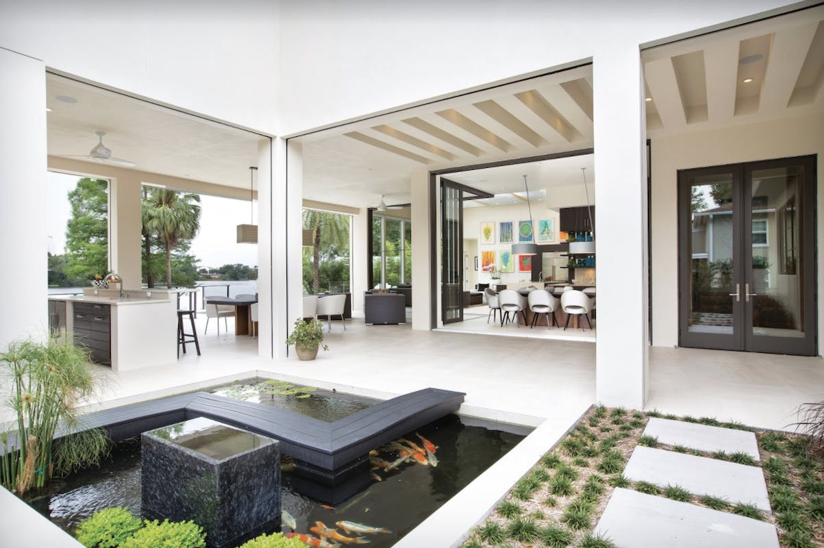 This courtyard home uses 12-foot sliding glass doors to open the interior living space to the lanai. The lanai itself is 1,132 square feet and features a koi pond, summer kitchen, and outdoor dining and seating area. Opening the house to the outdoors doubles the home&rsquo;s living space. Project: Private residence, Winter Park, Fla. Builder/architect: Phil Kean Design Group, Winter Park