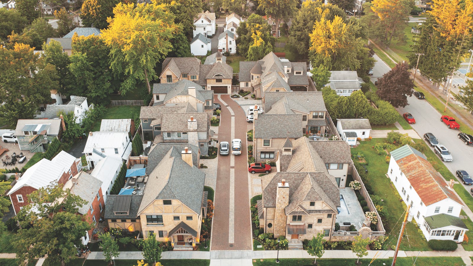 The cluster of seven single-family homes is built on a former industrial site within walking distance of downtown Saratoga Springs and the Saratoga Race Course. Each home features a unique stone or stucco exterior, and the community is unified by the use of matching custom cypress trim on the homes&rsquo; stoops, bracket details, and porches.