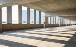 An empty parking garage overlooking a city An empty parking garage overlooking a city