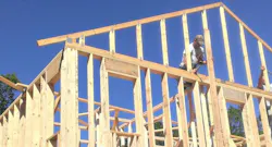 building crew framing a house using wood construction building crew framing a house using wood construction