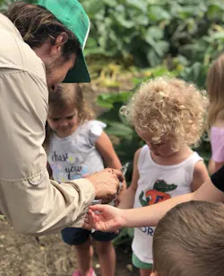 as part of Hillwood Communities' Live Smart campaign, farmers and kids plant seeds as part of Hillwood Communities' Live Smart campaign, farmers and kids plant seeds