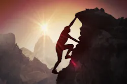 Man Climbing a mountain almost there Man Climbing a mountain almost there