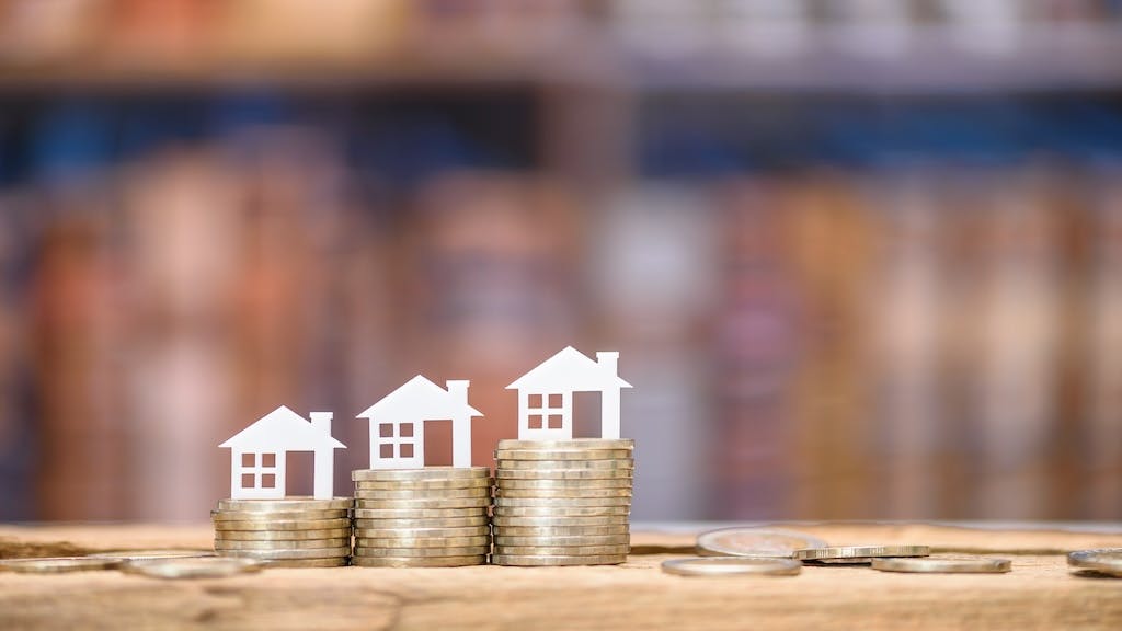 Model homes on stacks of coins in ascending order