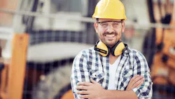 A construction worker in a yellow hard hat on at a jobsite A construction worker in a yellow hard hat on at a jobsite