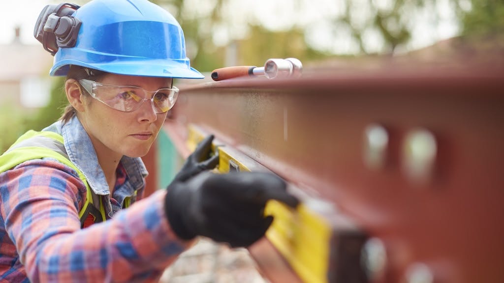 A woman works on a construction jobsite