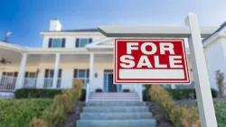 A home with a for sale sign in the front yard A home with a for sale sign in the front yard