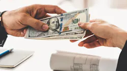 One individual hands money to another individual One individual hands money to another individual