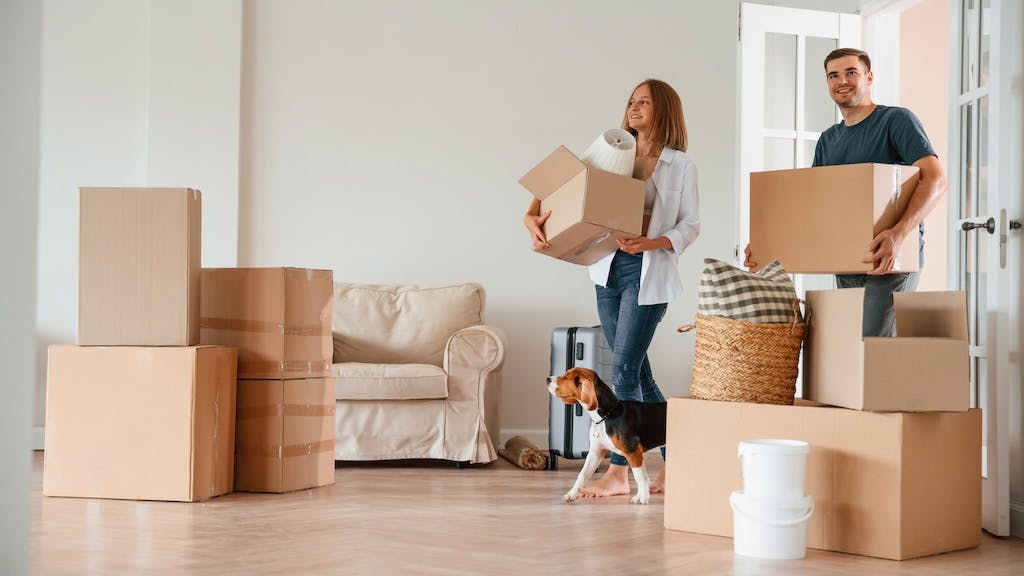 Cardboard boxes line the entry of a home as a family moves in.