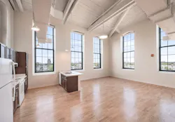 Interior space and kitchen in one of the units at the A & Indiana adaptive reuse project Interior space and kitchen in one of the units at the A & Indiana adaptive reuse project