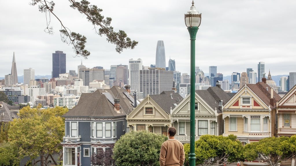 A man looks at the San Francisco skyline, the city with the largest price gap between renting and owning a home