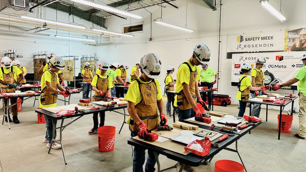 Students at Camp TRF wear hard hats and use construction tools to gain exposure to the skilled trades.