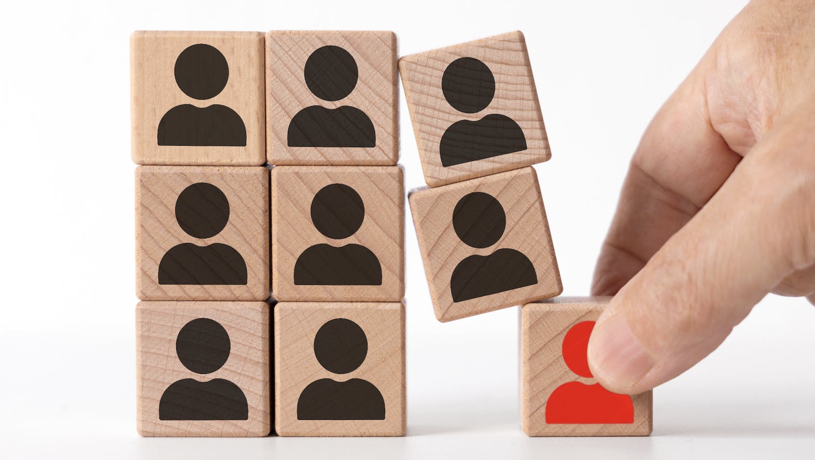 Removing a block from a stack of wooden block to represent reshuffling board members