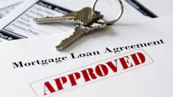 Mortgage application with the word 'Approved' stamped onto it in red ink. Mortgage application with the word 'Approved' stamped onto it in red ink.