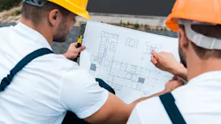 Home builders working together to figure out a home's floor plan so it is less expensive to build. Home builders working together to figure out a home's floor plan so it is less expensive to build.