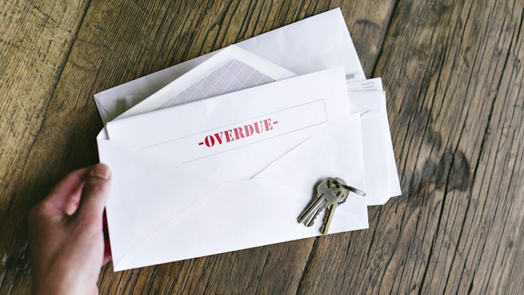 An envelope with an overdue bill notice inside of it