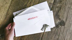 An envelope with an overdue bill notice inside of it An envelope with an overdue bill notice inside of it