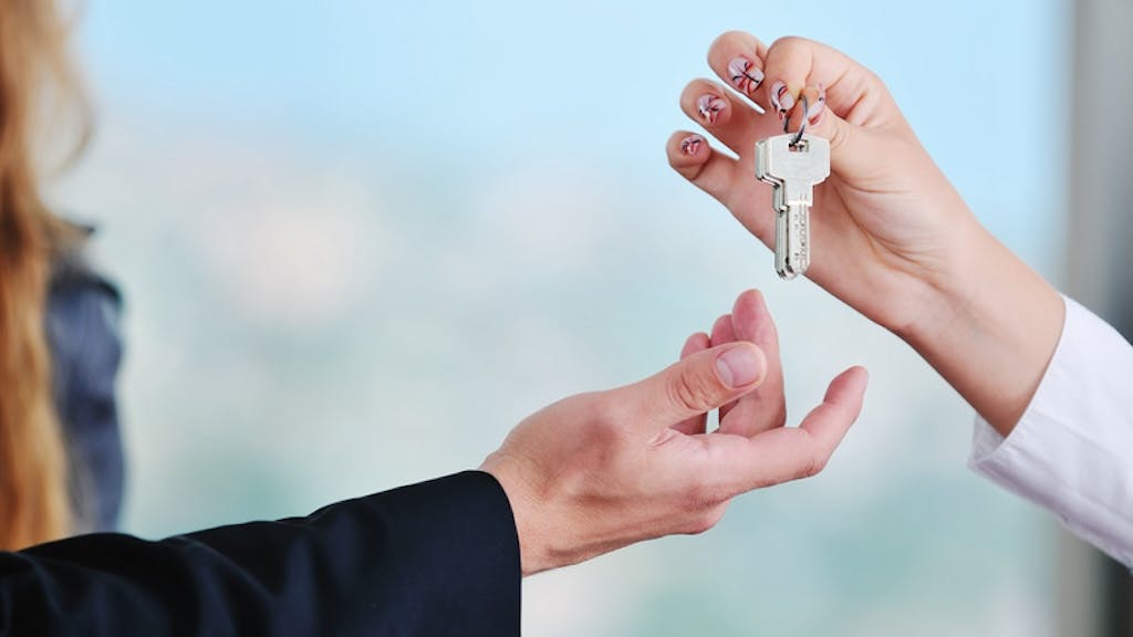 Homebuyer taking the keys from a real estate agent